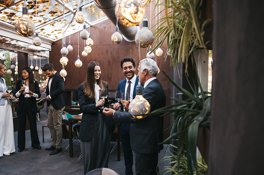 Group of people discussing something in a Fundraising Campaign holding glasses for drinks