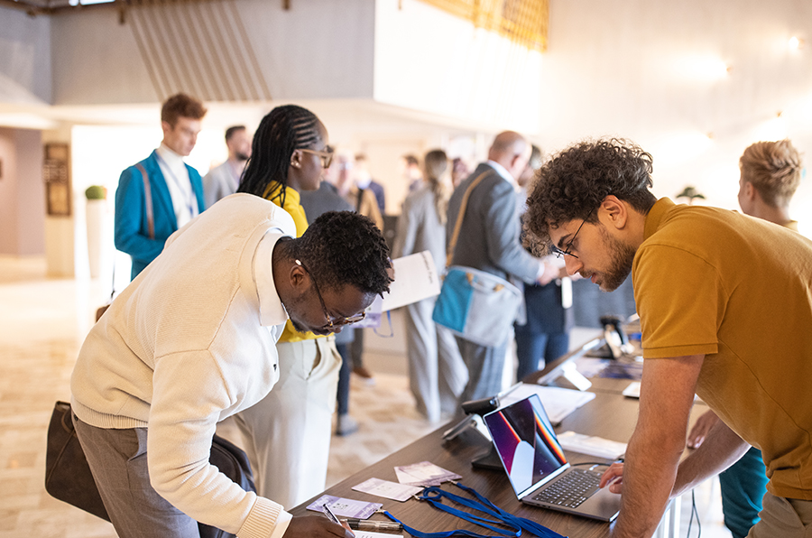 People registering at an association event for entry